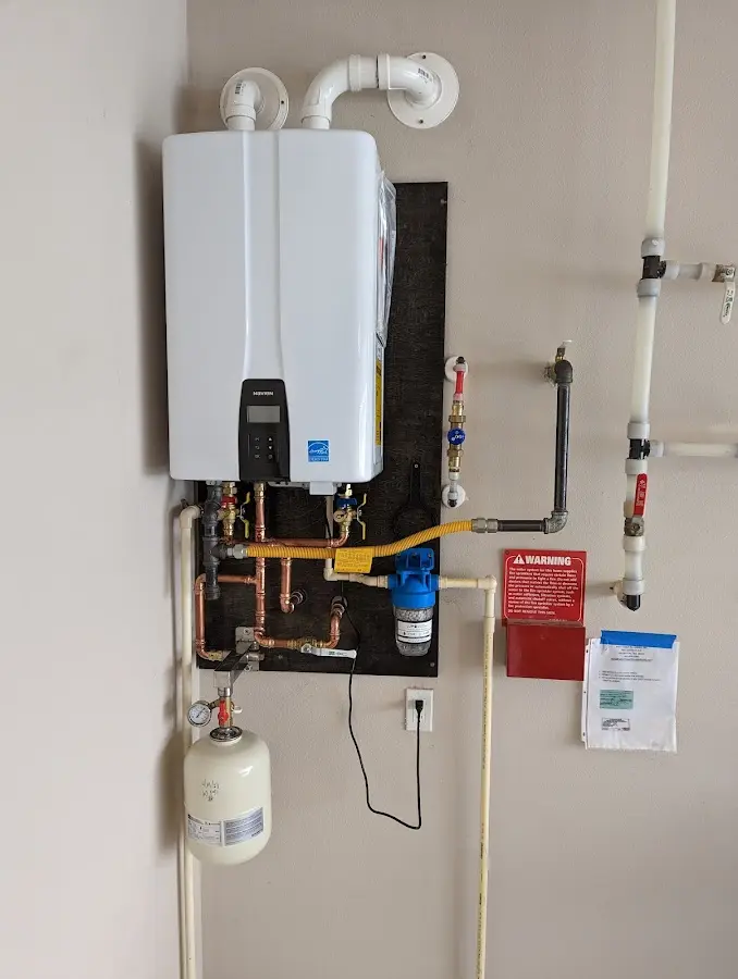 Professional plumber installing copper piping in a Lake Station home